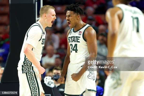 Julius Marble II and Joey Hauser of the Michigan State Spartans react after a play against the Davidson Wildcats during the second half in the first...