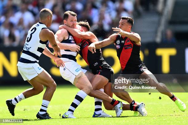 Patrick Dangerfield of the Cats is tackled during the round one AFL match between the Geelong Cats and the Essendon Bombers at Melbourne Cricket...