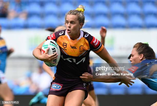 Lauren Brown of the Broncos breaks away from the defence during the round four NRL match between the Gold Coast Titans and the Brisbane Broncos at...