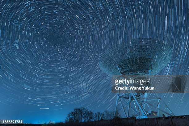 radio telescope in star orbit - satellite orbiting stock pictures, royalty-free photos & images