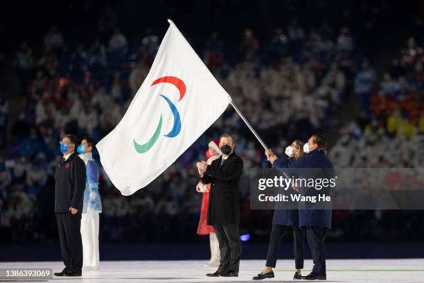 The Paralympic flag is waved inside the stadium during the Closing Ceremony on day nine of the 2022 Beijing Winter Paralympics at Beijing National...