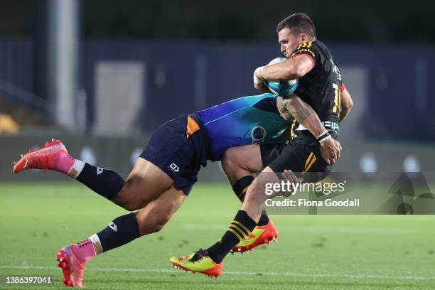 Bryn Gatland of the Chiefs is tackled by Levi Aumua of Moana Pasifika during the round five Super Rugby Pacific match between the Moana Pasifika and...