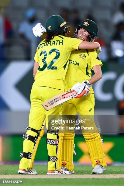 Tahlia McGrath and Beth Mooney of Australia celebrate the win during the 2022 ICC Women's Cricket World Cup match between India and Australia at Eden...