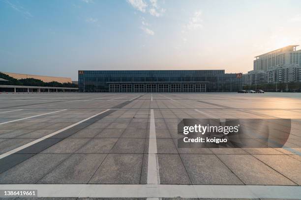 empty parking lot under blue sky and white clouds - fancy parking space stock pictures, royalty-free photos & images