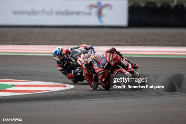 MotoGP rider Jack Miller of Australia and Ducati Lenovo Team leads to MotoGP rider Andrea Dovizioso of Italy and WithU Yamaha RNF MotoGP™ Team during...