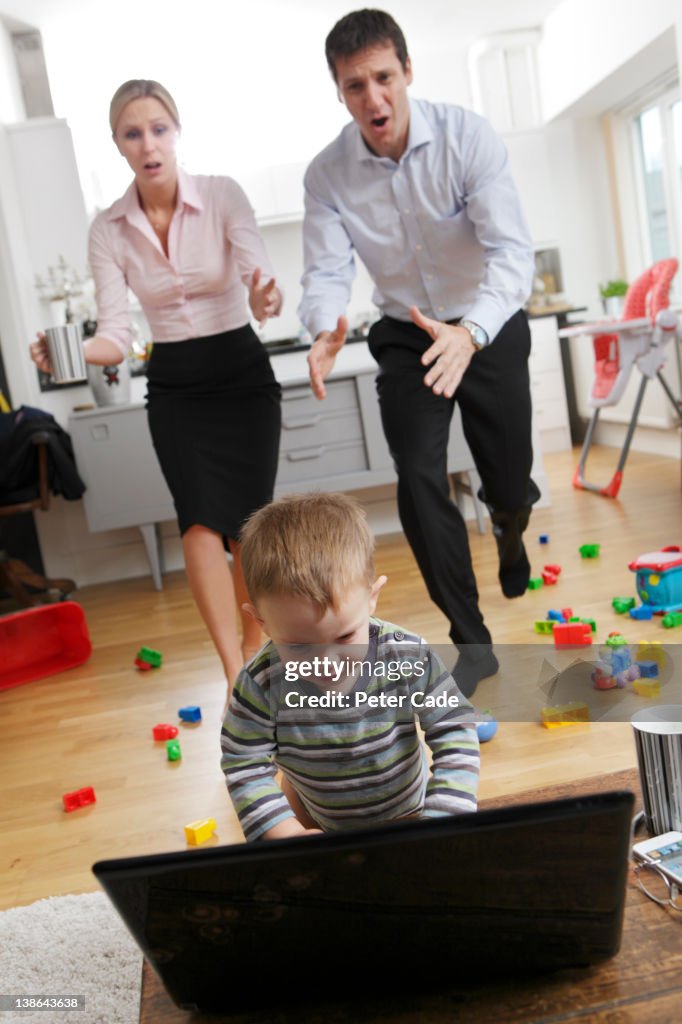 Parents Rushing Kids Working Parents Rushing To Stop Child On Laptop High-Res Stock Photo ...