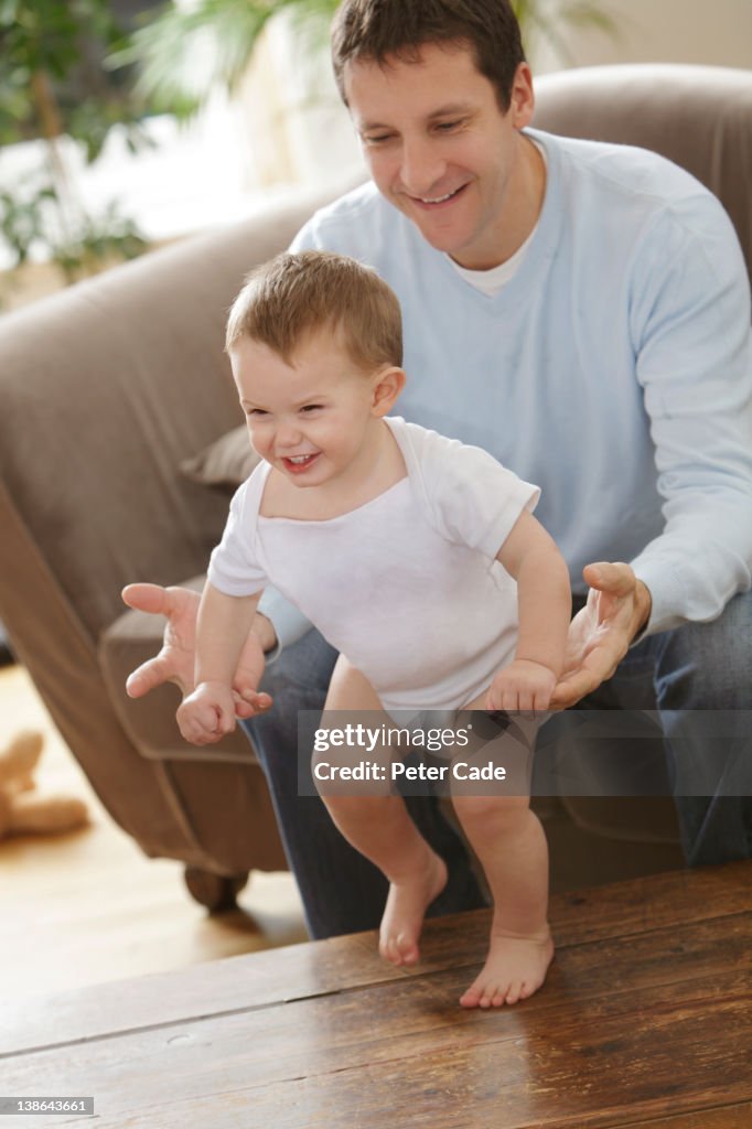 Father teaching son to walk