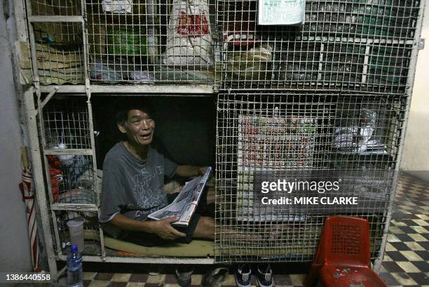 Hongkong-handover-10years-economy This picture taken 14 May, 2007 shows Kong Siu-kan sitting and reading the paper in a "cage dwelling", in one of...