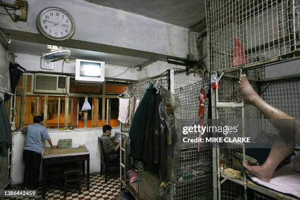 Hongkong-handover-10years-economy This picture taken 14 May, 2007 shows a group of men living in "cage dwellings", in one of the world's most densely...