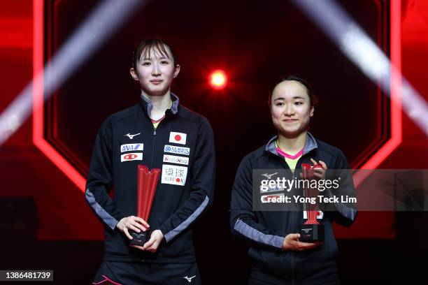 Hina Hayata and Mima Ito of Japan celebrate with the runner-up trophies following their loss to Wang Manyu and Sun Yingsha of China in the women's...