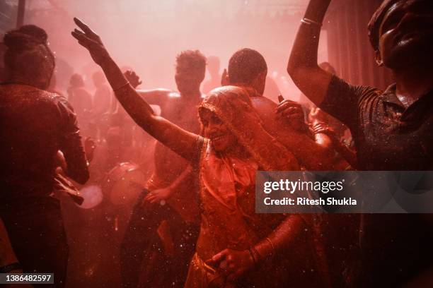 Hindu devotees dance during Huranga celebrations on March 19, 2022 at the Dauji Temple in Mathura, Uttar Pradesh, India. Huranga, which takes place a...