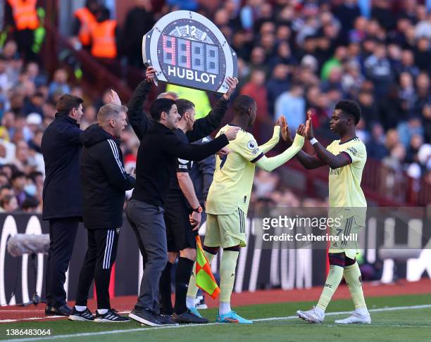 Nicolas Pepe replaces Bukayo Saka of Arsenal during the Premier League match between Aston Villa and Arsenal at Villa Park on March 19, 2022 in...