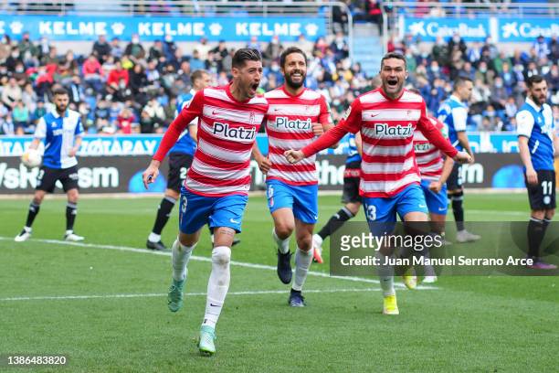 Sergio Escudero of Granada CF celebrates with teammates after scoring their team's first goal during the LaLiga Santander match between Deportivo...