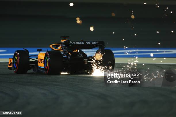 Sparks fly behind Daniel Ricciardo of Australia driving the McLaren MCL36 Mercedes on track during qualifying ahead of the F1 Grand Prix of Bahrain...