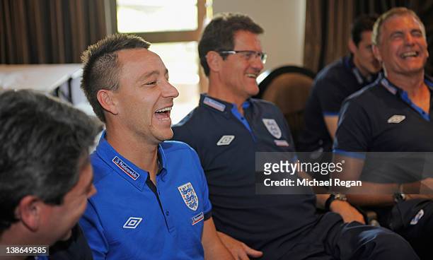 John Terry and manager Fabio Capello share a laugh with Prince William via video link after the England training session at the Royal Bafokeng Sports...