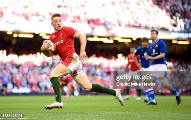 Josh Adams of Wales breaks through to score their sides third try during the Six Nations Rugby match between Wales and Italy at Principality Stadium...