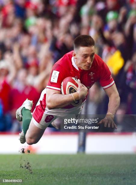 Josh Adams of Wales scores their sides third try during the Six Nations Rugby match between Wales and Italy at Principality Stadium on March 19, 2022...