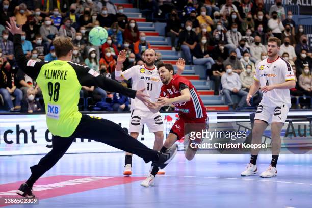 Peter Kovacsics of Hungary scores against Till Klimke of Germany during the international handball friendly match between Germany and Hungary at...