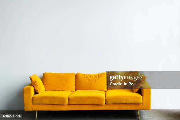 yellow sofa - yellow sofa stock pictures, royalty-free photos & images