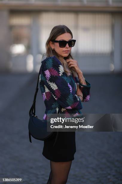 Aline Kaplan is seen wearing Celine shades, Polene Paris black bag, Isabel Marant Etoile shoulder padded colorful jacket, Massimo Dutti black cowboy...