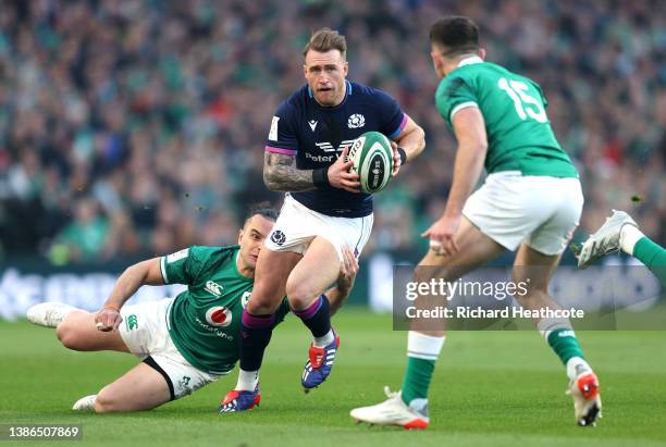Stuart Hogg of Scotland is tackled by James Lowe of Ireland during the Six Nations Rugby match between Ireland and Scotland at Aviva Stadium on March...