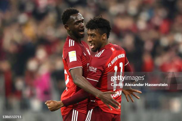 Kingsley Coman celebrates with teammate Tanguy Nianzou of FC Bayern Muenchen after scoring their team's first goal during the Bundesliga match...