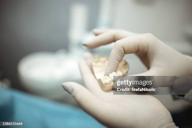 checking dental impression - dentist stock pictures, royalty-free photos & images