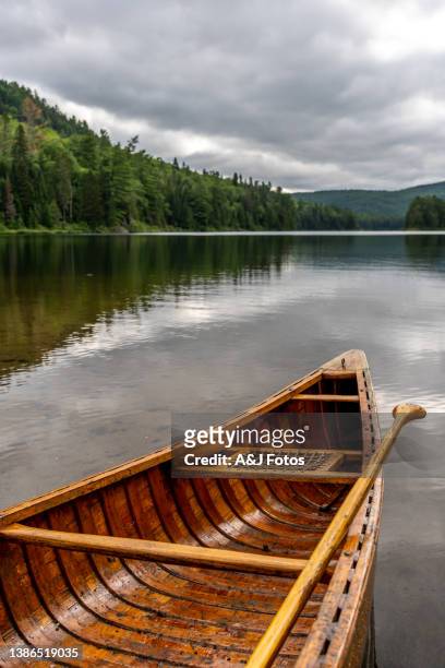a canoe next to a fishing lake in quebec. - oar stock pictures, royalty-free photos & images