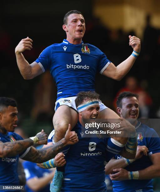 Italy fly half Paolo Garbisi is carried by Nicolo Cannone during the celebrations after the Six Nations Rugby match between Wales and Italy at...