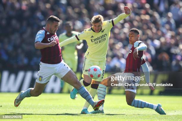 John McGinn and Jacob Ramsey of Aston Villa in action with Martin Odegaard of Arsenal during the Premier League match between Aston Villa and Arsenal...