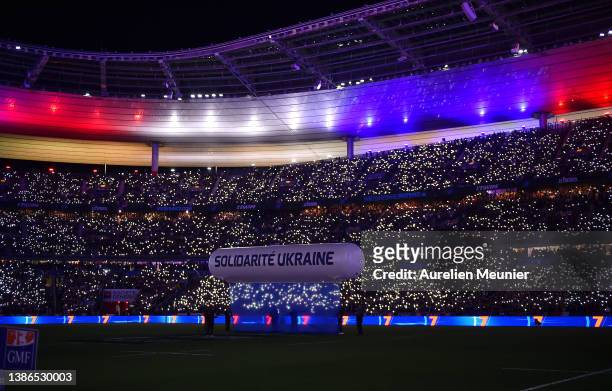 An inflatable banner which says Solidarite Ukraine, is brought onto the pitch to indicate peace and sympathy with Ukraine prior to during the...