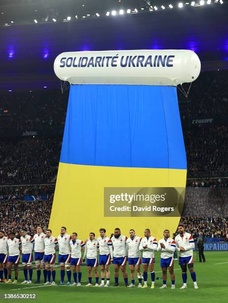 France line up for their national anthem as an inflatable banner which says Solidarite Ukraine, is brought onto the pitch to indicate peace and...