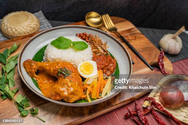 nasi lemak with  chicken curry rendang - traditional malay food stock pictures, royalty-free photos & images