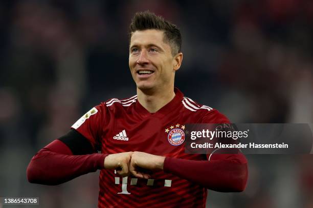 Robert Lewandowski of FC Bayern Muenchen celebrates after scoring their team's third goal from the penalty spot during the Bundesliga match between...