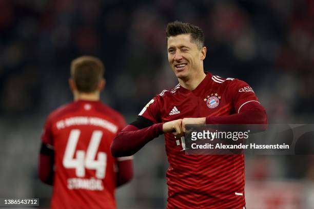 Robert Lewandowski of FC Bayern Muenchen celebrates after scoring their team's third goal from the penalty spot during the Bundesliga match between...