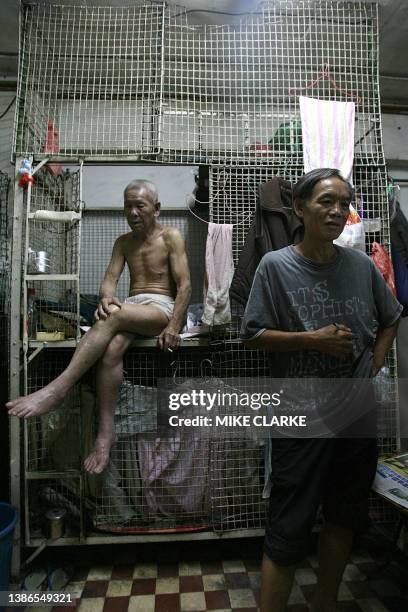 Hongkong-handover-10years-economy This picture taken 14 May, 2007 shows 78-year-old Tai Yum-po sitting on his bed in a "cage dwelling", in one of the...