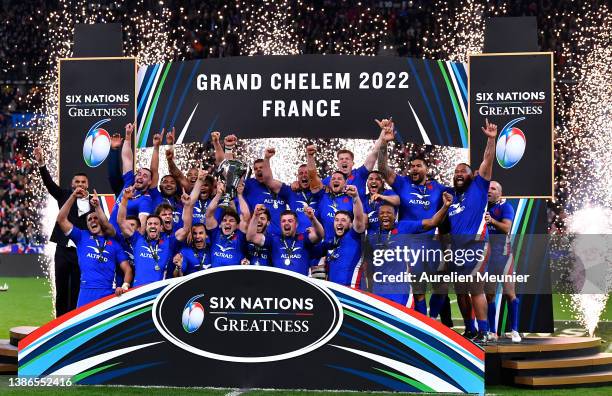 Antoine Dupont of France lifts the Six Nations Trophy with teammates after victory in the during the Guinness Six Nations Rugby match between France...