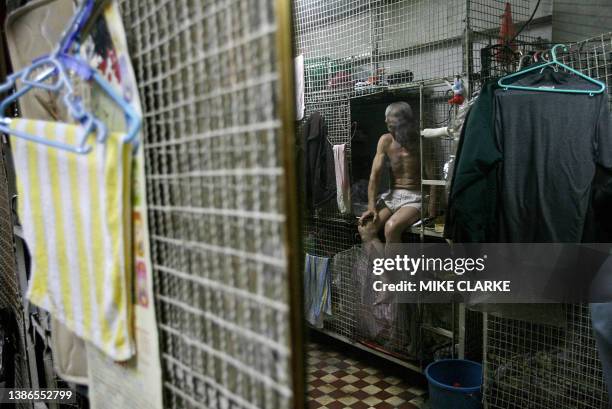 Hongkong-handover-10years-economy This picture taken 14 May, 2007 shows 78-year-old Tai Yum-po sitting on his bed in a "cage dwelling", in one of the...