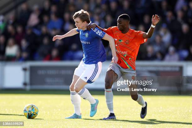 James Berry-McNally of Macclesfield battles for possession with Michael Afuye of Avro during the North West Counties Football League match between...