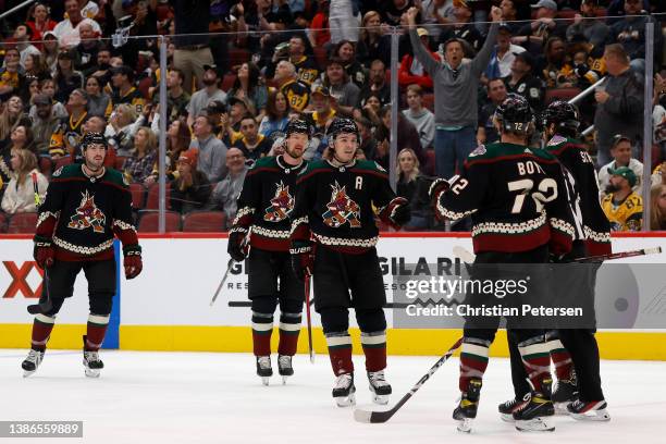 Clayton Keller of the Arizona Coyotes celebrates with Travis Boyd and Nick Schmaltz after scoring a goal against the Pittsburgh Penguins during the...