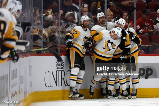 Kasperi Kapanen of the Pittsburgh Penguins is congratulated by Jeff Carter, John Marino and Mike Matheson after scoring a goal against the Arizona...