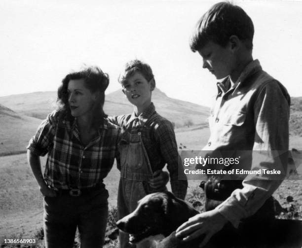 View of American actress Frances Dee and her sons , Jody McCrea and David McCrea , with a pet dog on their ranch, Thousand Oaks, California, 1945.