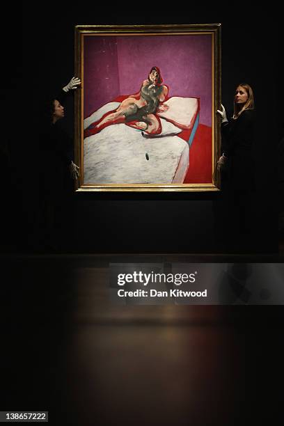 Christie's auction house employees hang a 'Portrait of Henrietta' by Francis Bacon during a press preview of Post War And Contemporary Art at...