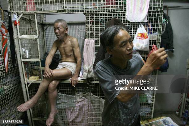 Hongkong-handover-10years-economy This picture taken 14 May, 2007 shows 78-year-old Tai Yum-po and Kong siu-kan chat outside "cage dwellings", in one...