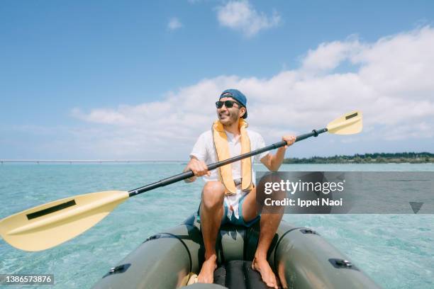 man enjoying sea kayaking on tropical water, okinawa, japan - paddla bildbanksfoton och bilder