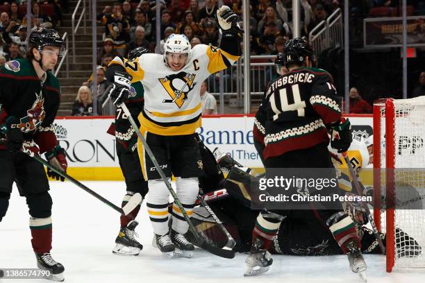 Sidney Crosby of the Pittsburgh Penguins celebrates after scoring a goal against goaltender Scott Wedgewood of the Arizona Coyotes during the third...