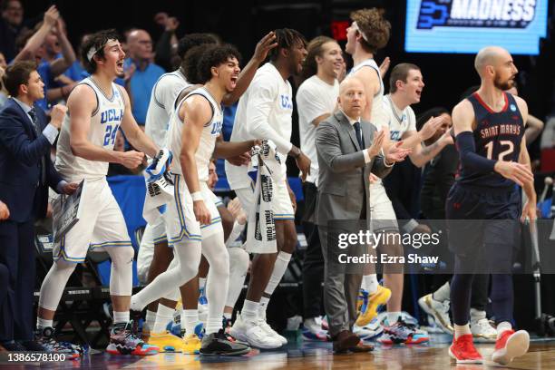 Head coach Mick Cronin of the UCLA Bruins and the players celebrate after forcing a shot clock violation during the first half against the St. Mary's...