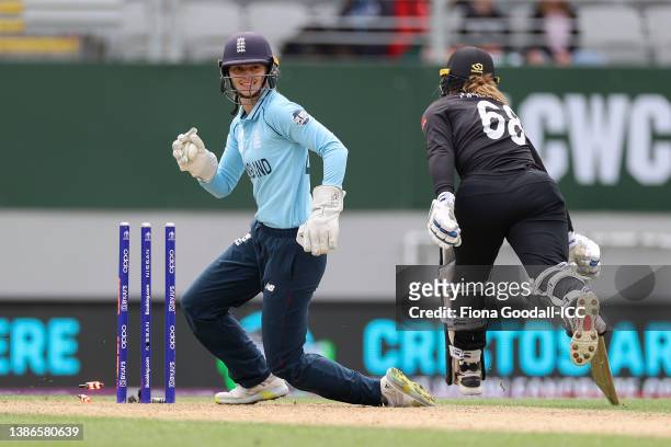 Amy Jones of England celebrates after taking the wicket of Brooke Halliday of New Zealand during the 2022 ICC Women's Cricket World Cup match between...