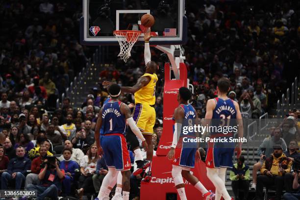 LeBron James of the Los Angeles Lakers scores a basket against the Washington Wizards during the second quarter at Capital One Arena on March 19,...