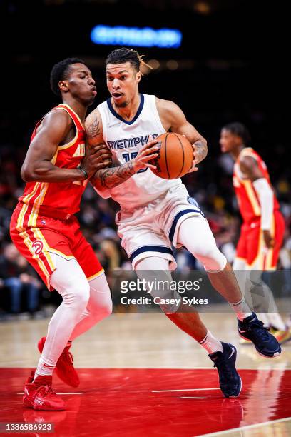Brandon Clarke of the Memphis Grizzlies handles the ball as Onyeka Okongwu of the Atlanta Hawks defends during a game at State Farm Arena on March...